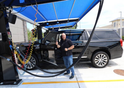 Happy car wash customer in vacuum area