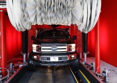 Car going through car wash tunnel