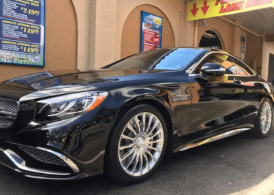 Black fancy car outside of wash