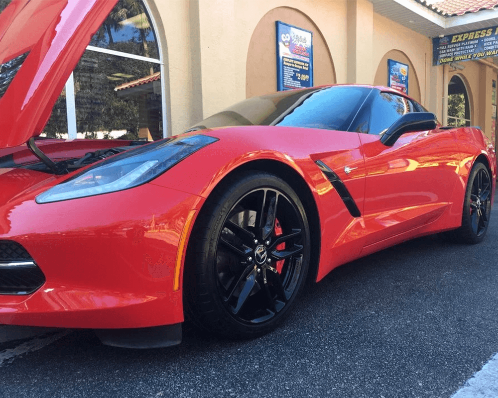 Red fancy car outside of wash